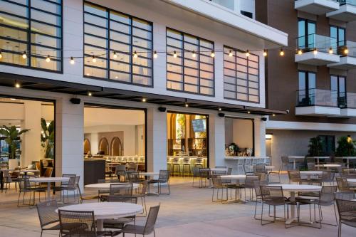 a restaurant with tables and chairs in front of a building at Courtyard by Marriott Sand City Monterey in Sand City