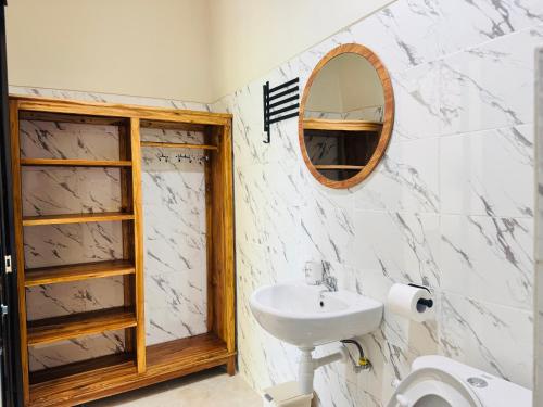 a bathroom with a sink and a mirror at Umah Kak Pasek in Jimbaran
