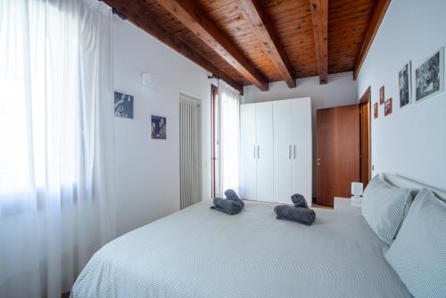 a bedroom with a bed with two slippers on it at la promenade in Vicenza
