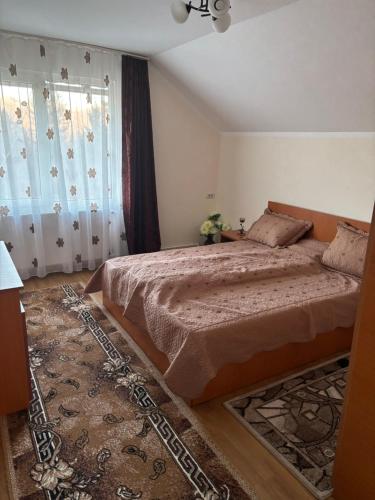 a bedroom with a large bed and a rug at la Sat in Marga