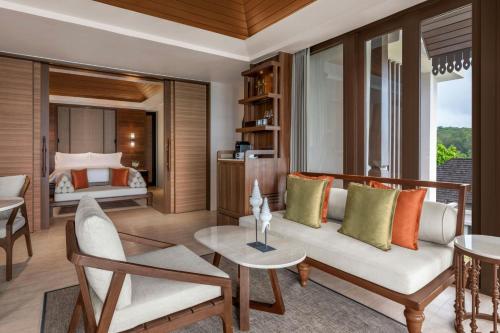 a living room with a couch and a bed at The Ritz-Carlton, Koh Samui in Choeng Mon Beach
