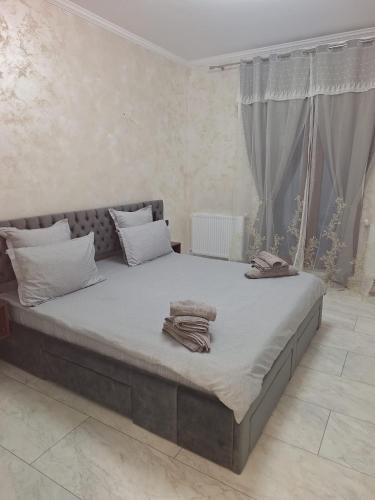 a bedroom with a large bed with towels on it at ANY MARY Apart ZONA 0 in Tulcea