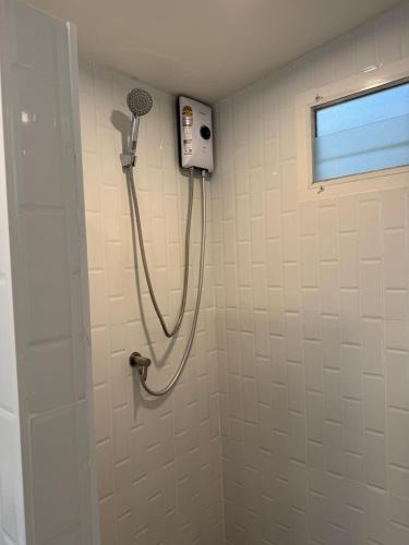 a shower in a bathroom with a shower at Lazy Garden Hostel in Phra Ae beach
