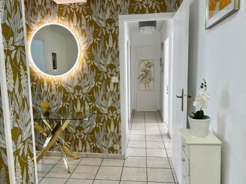 a hallway with a mirror and a tile floor at Le Catalogne 3 in Perpignan