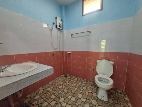 a bathroom with a toilet and a sink at Sam roi yot Sea sight Resort in Sam Roi Yot