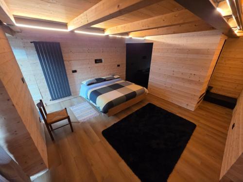 an overhead view of a bedroom with a bed and a chair at Muranche Loft S1 in Valtournenche