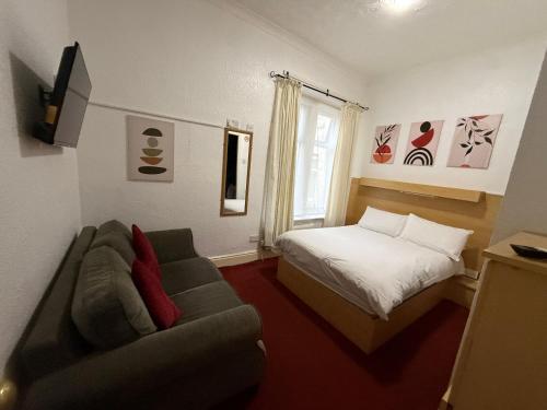 a living room with a couch and a bed at Glen Allan Hotel in Blackpool