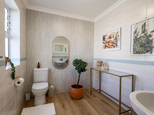 a bathroom with a toilet and a sink at Salt & Butter in Hermanus