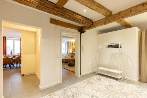 a living room with white walls and a wooden ceiling at Altstadt Loft XL I 90 qm I 2 Schlafzimmer I 2 Arbeitsplätze I 6 Gäste in Passau