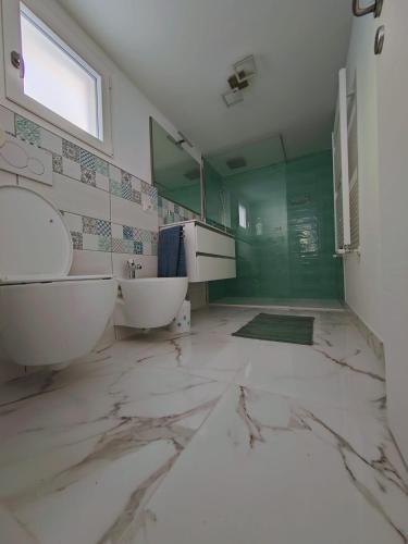a large bathroom with two sinks and a mirror at Casa Sole in Cannobio