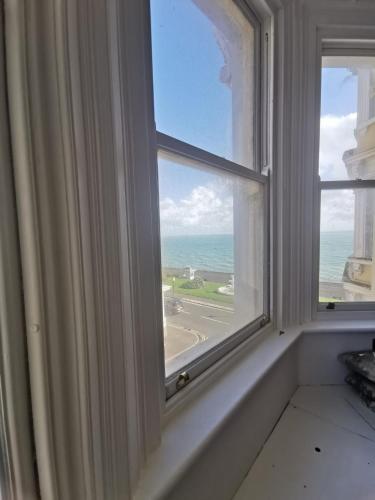 an open window with a view of the ocean at Victoria Guest House in Ramsgate