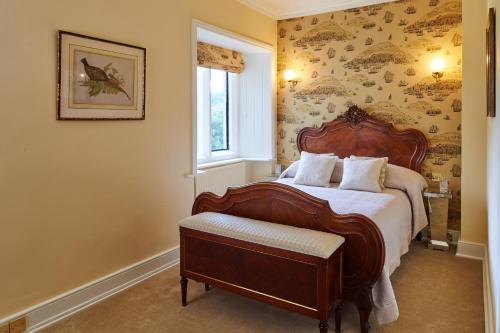 a bedroom with a large bed and a window at Palé Hall in Bala