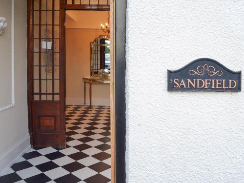 a sign on the side of a building with a checkerboard floor at Sandfield The Promenade in Southport