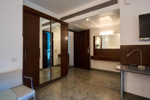 a hotel room with a hallway with a mirror at Urban Opulence in Bangalore
