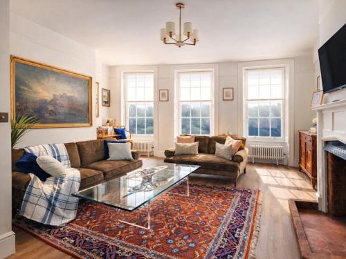 a living room with a couch and a glass table at Consorts and Concubines in Windsor