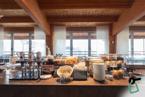 a kitchen with a counter with food on it at Hotiday Milano Navigli in Milan