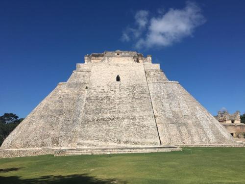 a large pyramid building with a blue sky in the background at Hostal La Ermita in Mérida
