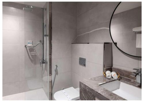 a bathroom with a shower and a toilet and a sink at Vittori Garden in Riyadh