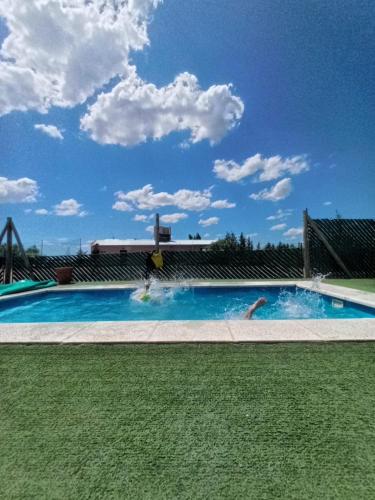 a swimming pool with two people in the water at Casa de campo in Puerto Madryn