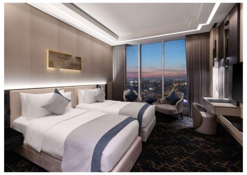 two beds in a hotel room with a view at Vittori Garden in Riyadh