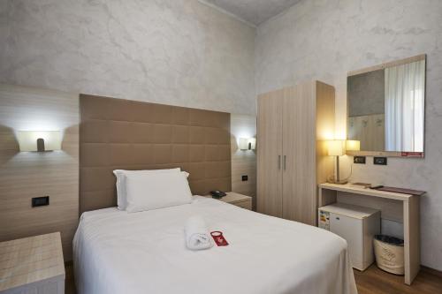 a bedroom with a large white bed in a room at Hotel Galimberti in Turin