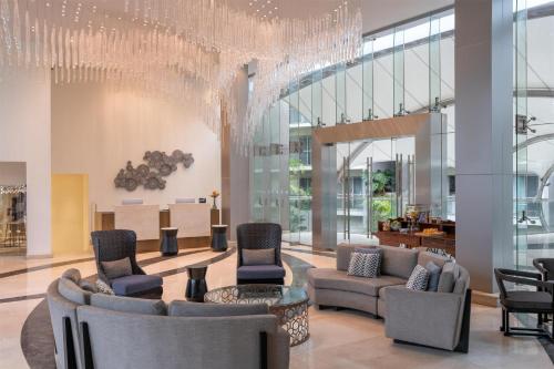 a lobby with couches and chairs and a chandelier at Radisson Blu Hotel & Residence Nairobi Arboretum in Nairobi