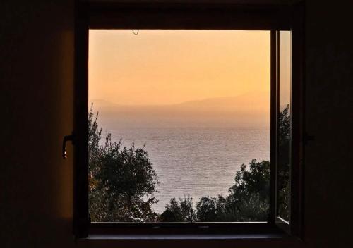 a window with a view of the ocean at Achilles Cottage in Kardamyli