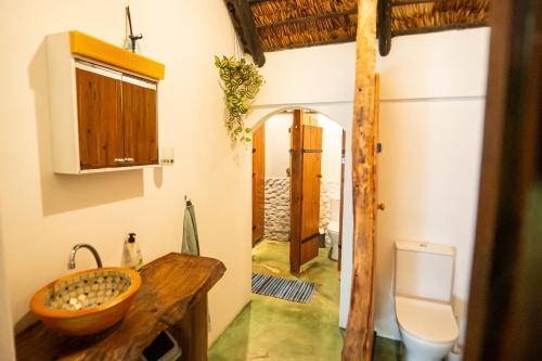 a bathroom with a sink and a toilet at Kitesurf Tofo House - 1 minute walk from beach and center in Praia do Tofo