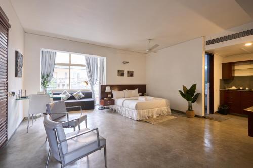 a bedroom with a bed and a table and chairs at Urban Opulence in Bangalore