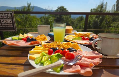 a table topped with plates of food on a table at Moon Village Comarnic in Sinaia