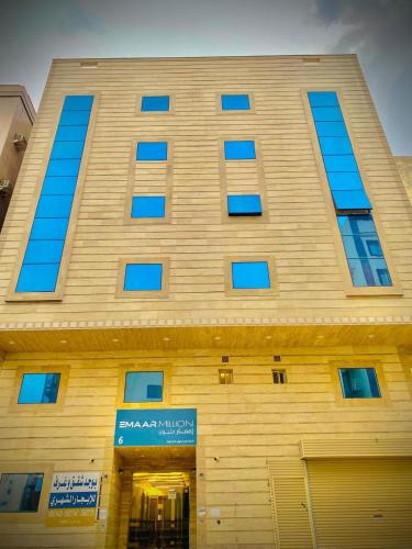 a large building with blue windows on the side of it at Emaar million6 in Quai