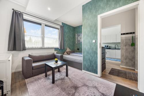 a living room with a couch and a table at Heide Ferienwohnung Süd Nr-2 in Schneverdingen