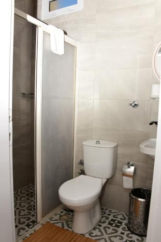 a small bathroom with a toilet and a sink at Teras Motel 12 Adults Only in Foça
