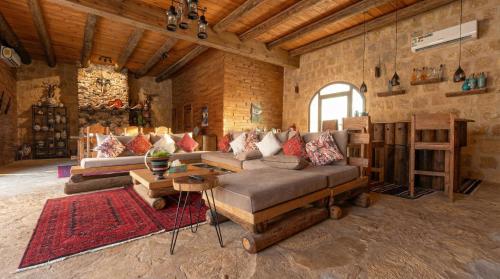 a living room with a couch and a table at Golden Heights Resort in Al Ḩanī