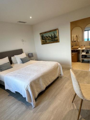 a bedroom with a large bed and a table at Prestige villa Estrella in Fayence