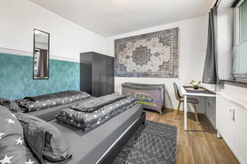 a bedroom with two beds and a desk in it at Heide Ferienwohnung Nord Nr-1 in Schneverdingen