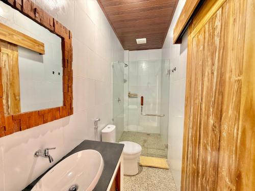 a bathroom with a sink and a toilet and a shower at Tanhana Seminyak in Kerobokan
