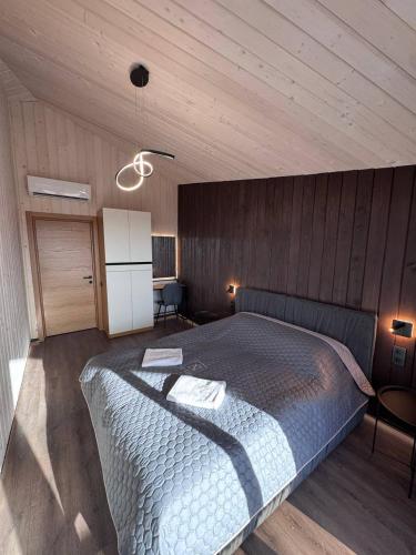 a bedroom with a large bed in a wooden room at Evelin in Maidan Village