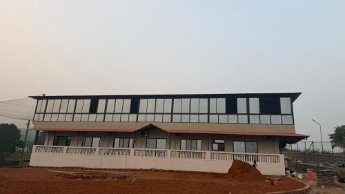 a large building with a lot of windows at The Sixth Abode Farms 5 BHK Villa with Swimming Pool, Turf, Lawn & Indoor Games- Khopoli in Jambhulpāda