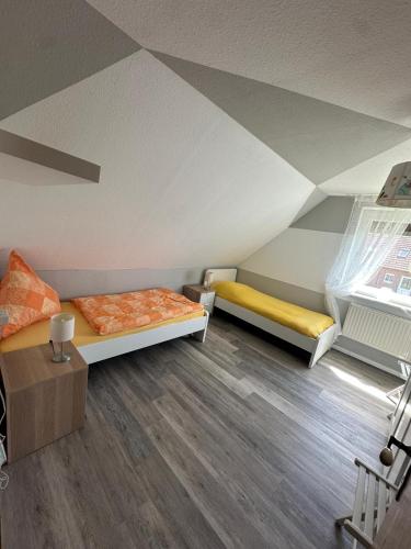 a room with two beds in a attic at Ferienwohnung Wildblume in Fehmarn