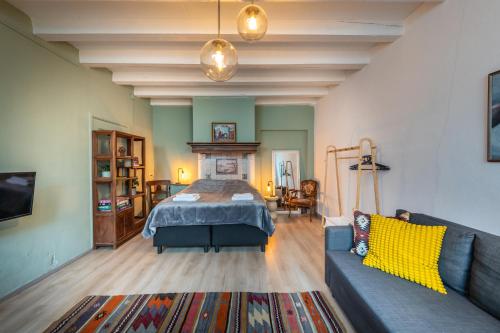 a living room with a bed and a couch at Cozy two-room city center apartment with garden in Amersfoort