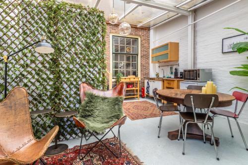 a kitchen with a table and chairs in a room at Cozy two-room city center apartment with garden in Amersfoort