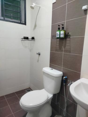 a bathroom with a toilet and a sink at Stingless Bee Homestay in Kluang