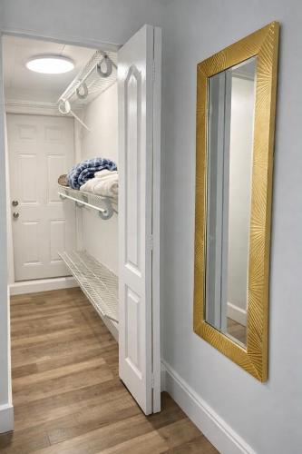 a bathroom with a mirror and a closet at Modern Hard Rock Apartment in Miramar