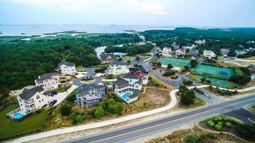 an aerial view of a home with the ocean at Puppy Love - Corolla, Villages at Ocean Hill, Pool, Hot Tub, Nearby Amenities, Lighthouse, Pets OK in Corolla