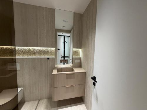 a bathroom with a sink and a mirror at RETLAV LUXURY Apartment in San Donato Milanese