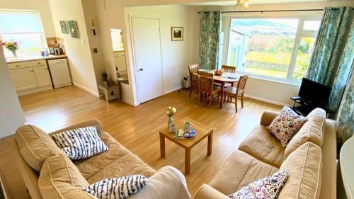 a living room with two couches and a table at CROYDE SEAGRASS 2 Bedrooms in Croyde