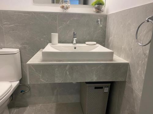 a bathroom with a sink and a toilet at Upendo Apartment 2 Bedroom in Tilisi in Gatimu