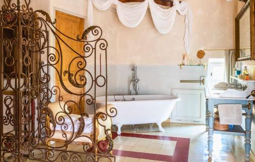a bathroom with a white tub and a sink at Justin de Provence in Orange