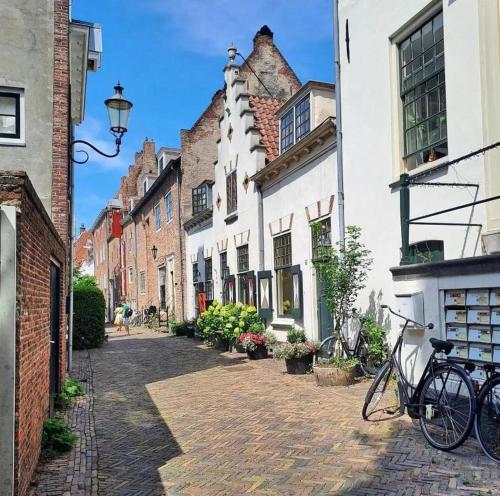 a cobblestone street with buildings and bikes parked on the street at Cozy two-room city center apartment with garden in Amersfoort